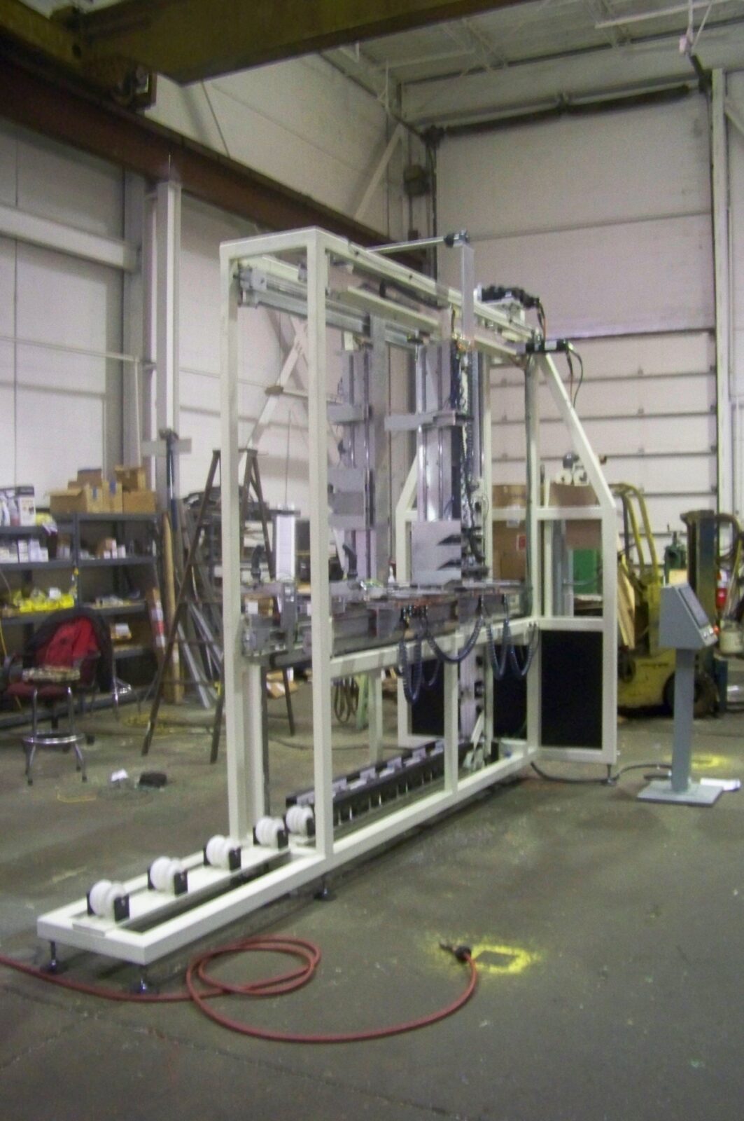 emi-automated SDL grille machine with bottom horizontal rollers, frame structure, and separate HMI control console.